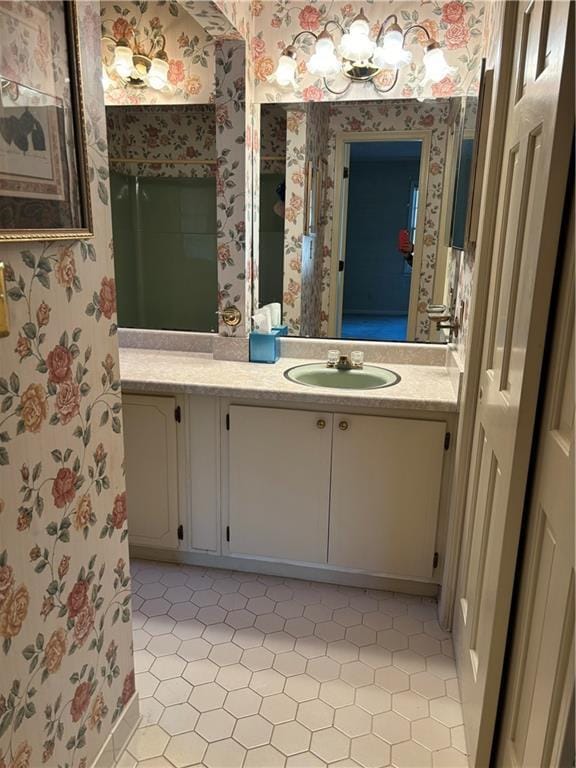 bathroom featuring a shower and vanity