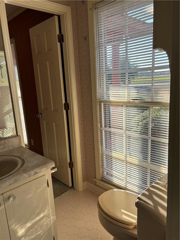 bathroom featuring toilet, tile patterned floors, and vanity