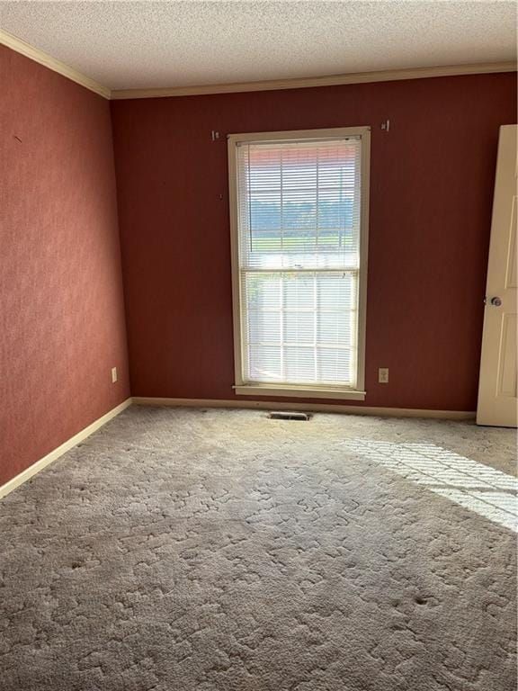 carpeted empty room with a textured ceiling and ornamental molding