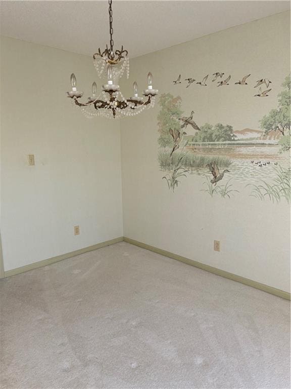 carpeted spare room with a notable chandelier