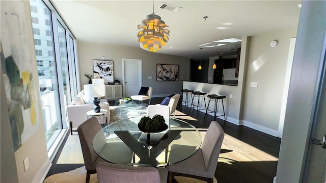 dining area with hardwood / wood-style flooring and floor to ceiling windows