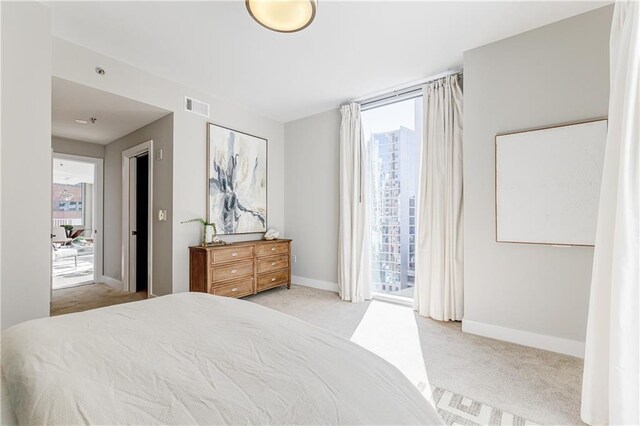 bedroom with light carpet and access to exterior