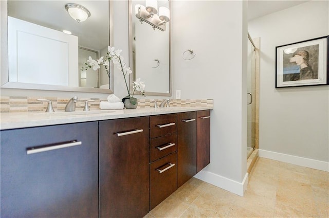 bathroom with an enclosed shower, vanity, backsplash, and tile patterned floors