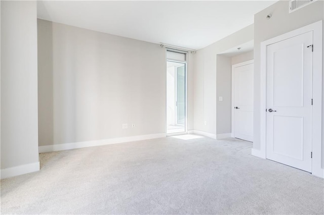 unfurnished room featuring light carpet
