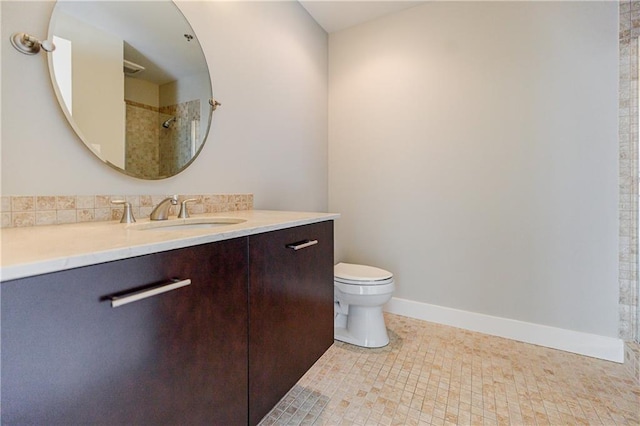 bathroom with vanity, toilet, and a shower
