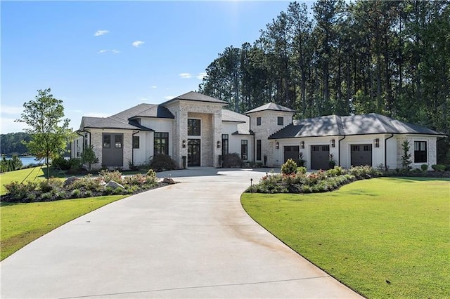 view of front facade with concrete driveway, a front lawn, an attached garage, and stone siding