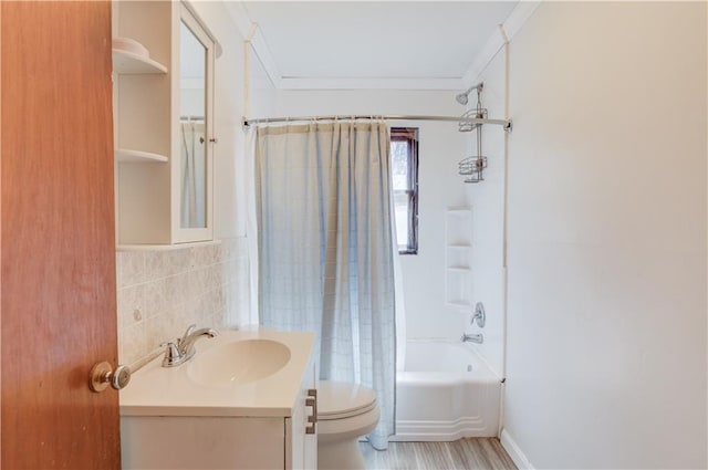 bathroom with toilet, tile walls, vanity, shower / tub combo with curtain, and crown molding