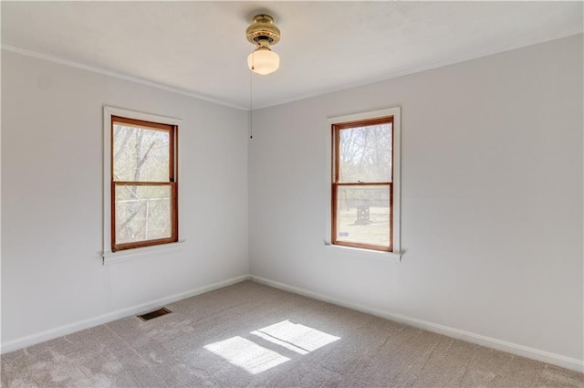 unfurnished room featuring light carpet, a healthy amount of sunlight, baseboards, and visible vents