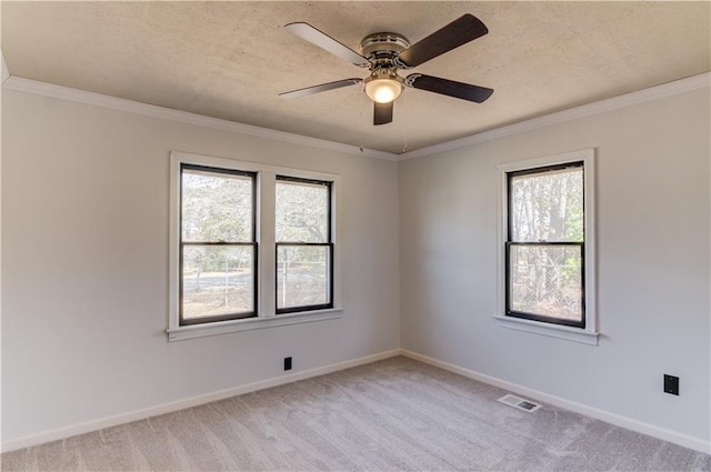 unfurnished room with light carpet, baseboards, visible vents, and crown molding