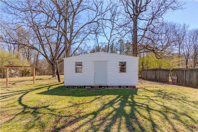 view of outbuilding with fence and an outbuilding