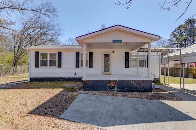 view of front of home with a porch, a front yard, and fence