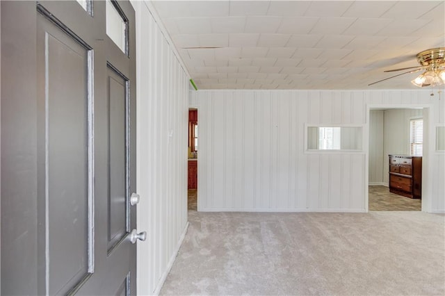 empty room featuring light carpet and a ceiling fan