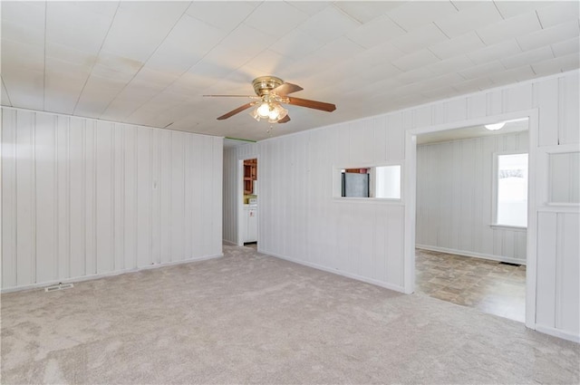 empty room with ceiling fan and carpet flooring