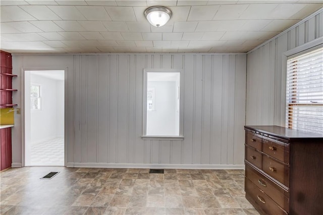 unfurnished room featuring visible vents and plenty of natural light