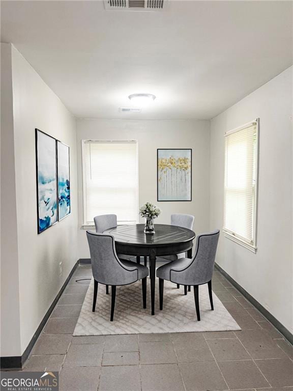 5770 Satterfield Dr, Macon, GA 31206 - dining room with baseboards and dark tile patterned flooring