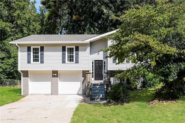 split foyer home with a front yard and a garage