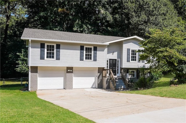 bi-level home featuring a front lawn and a garage