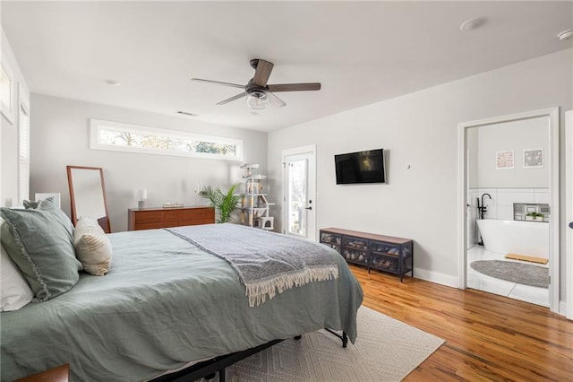 bedroom featuring ceiling fan, connected bathroom, wood finished floors, visible vents, and baseboards