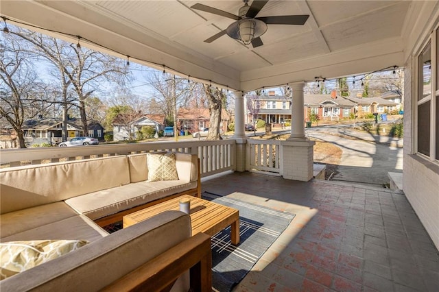 view of patio / terrace featuring ceiling fan, an outdoor living space, and a residential view