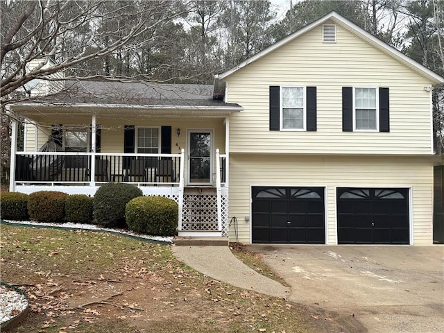 split level home with a garage and a porch