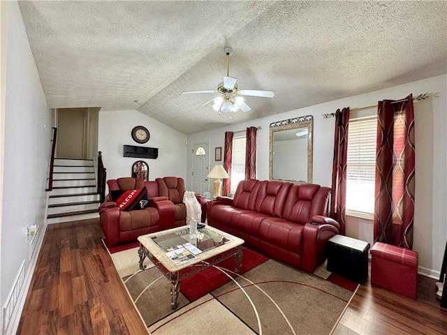 living room featuring lofted ceiling, wood-type flooring, ceiling fan, and plenty of natural light