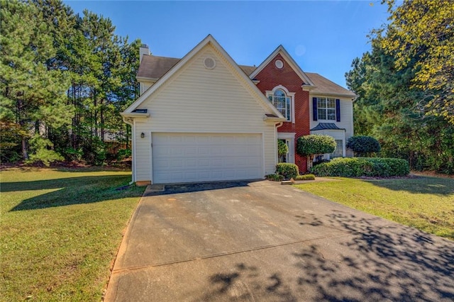 view of front of home featuring a front lawn and a garage