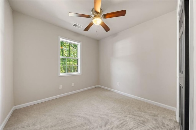 carpeted spare room with ceiling fan