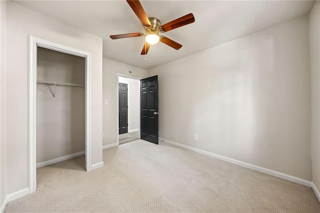 unfurnished bedroom featuring light colored carpet, a closet, and ceiling fan