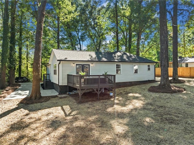 rear view of property featuring a deck