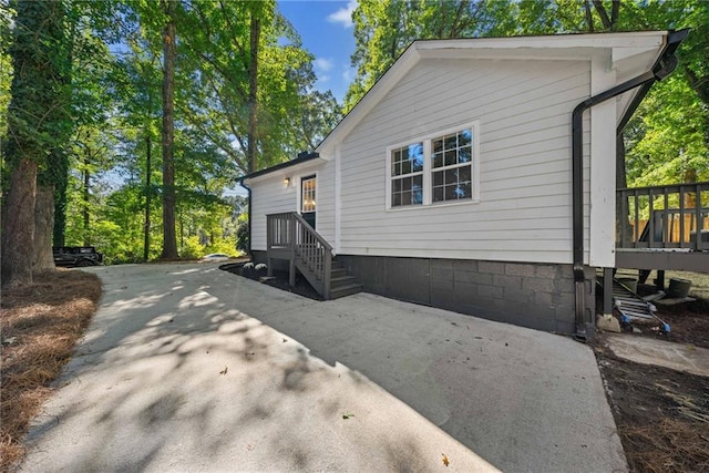 view of side of home with a wooden deck