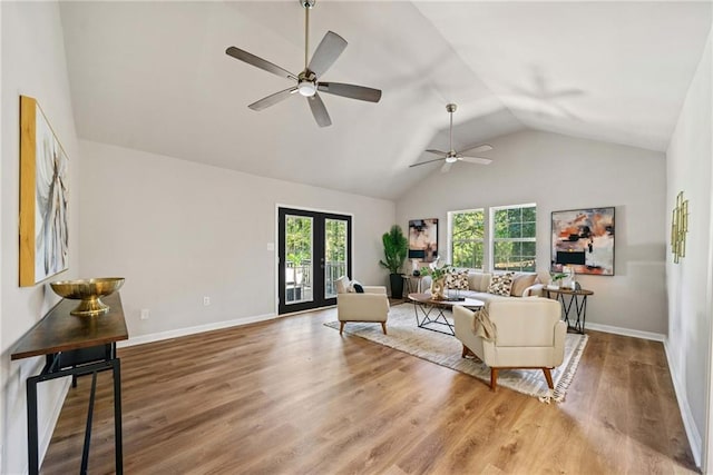 living room with french doors, hardwood / wood-style flooring, ceiling fan, and vaulted ceiling