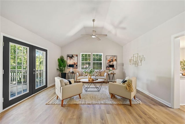 sitting room featuring light hardwood / wood-style flooring, french doors, vaulted ceiling, and a wealth of natural light