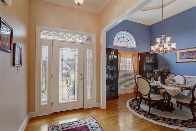 entrance foyer with light hardwood / wood-style flooring and a notable chandelier