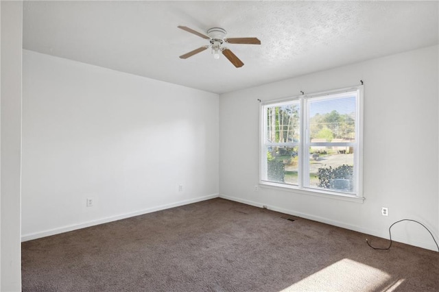 empty room featuring carpet flooring and ceiling fan