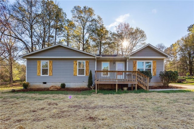 back of house with a deck and a yard