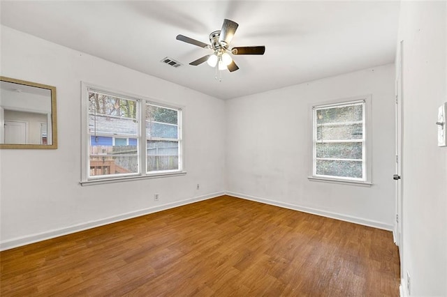 3723 Glenwood Rd, Decatur, GA 30032 - spare room featuring wood finished floors, baseboards, and ceiling fan