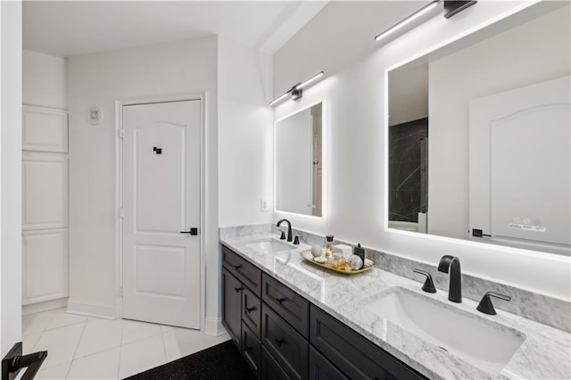 full bathroom with double vanity, tile patterned flooring, and a sink