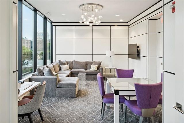 living area with an inviting chandelier, visible vents, floor to ceiling windows, and recessed lighting