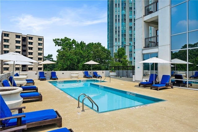 pool with a patio and fence