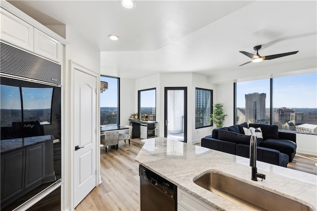 kitchen with dishwasher, open floor plan, refrigerator, a city view, and a sink