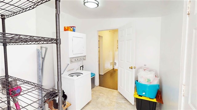 laundry room featuring stacked washer / drying machine