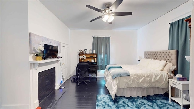 bedroom with dark hardwood / wood-style floors and ceiling fan