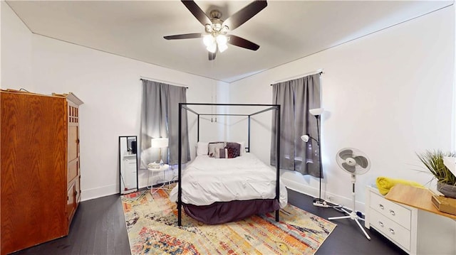 bedroom with ceiling fan and dark hardwood / wood-style flooring