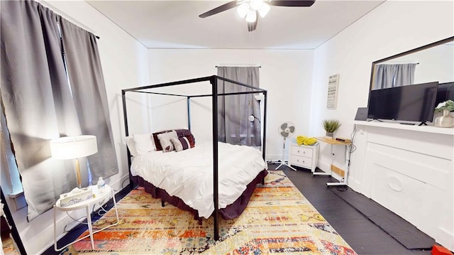 bedroom featuring ceiling fan and dark wood-type flooring