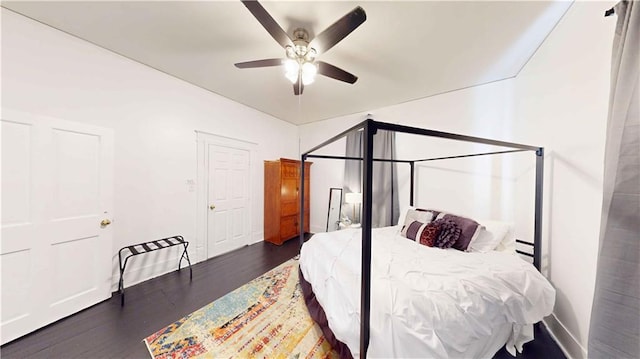 bedroom with ceiling fan and dark wood-type flooring