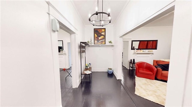 corridor featuring a chandelier, dark hardwood / wood-style floors, and crown molding