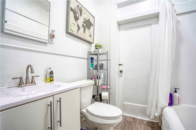 full bathroom featuring shower / tub combo with curtain, vanity, wood-type flooring, and toilet