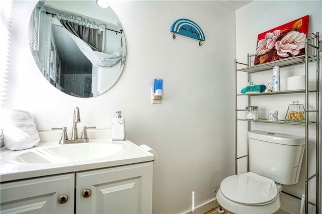 bathroom featuring vanity and toilet