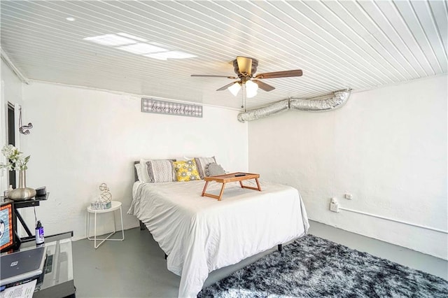 bedroom featuring ceiling fan and concrete floors