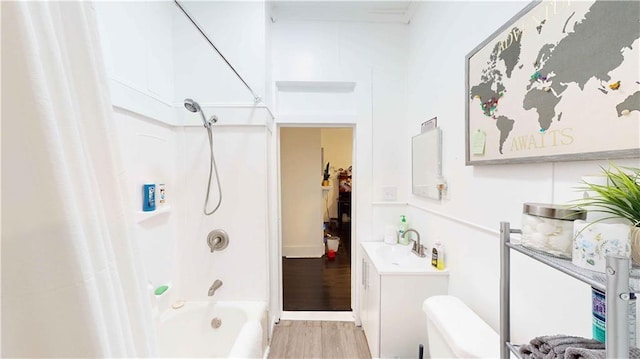 bathroom featuring wood-type flooring, vanity, and shower / tub combo